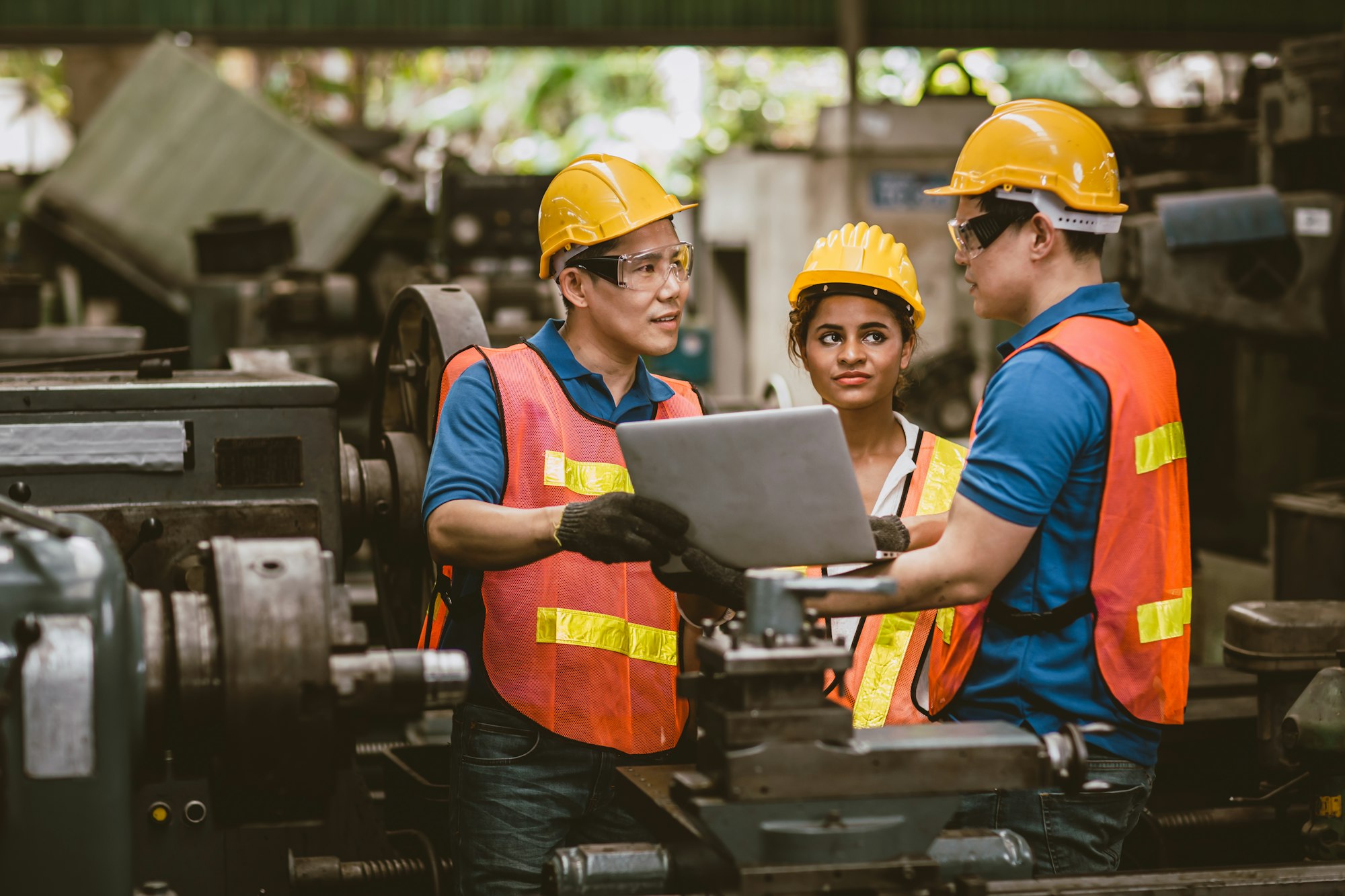 Engineer training talking technical explain to new employee and show information on laptop computer.